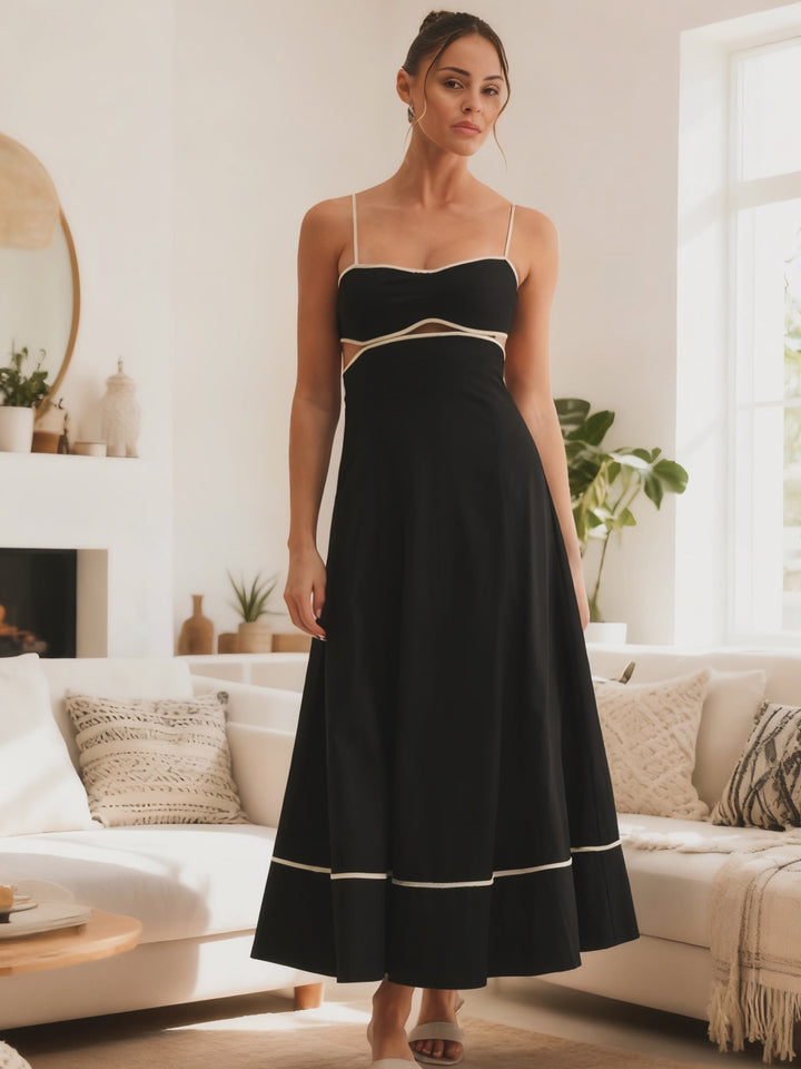 Woman wearing a black dress with white trim in a living room setting