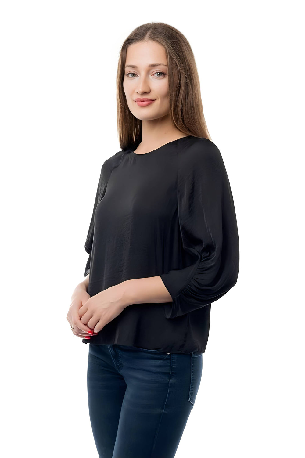 A woman modeling a black long-sleeve blouse with a relaxed, slightly sheer fabric and dark blue jeans, set against a plain white background.