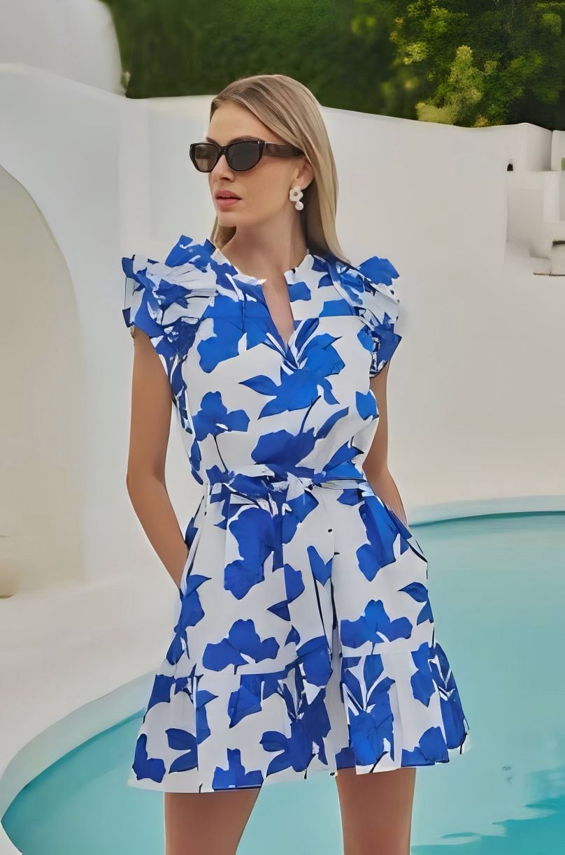 Woman wearing a blue floral dress by a pool