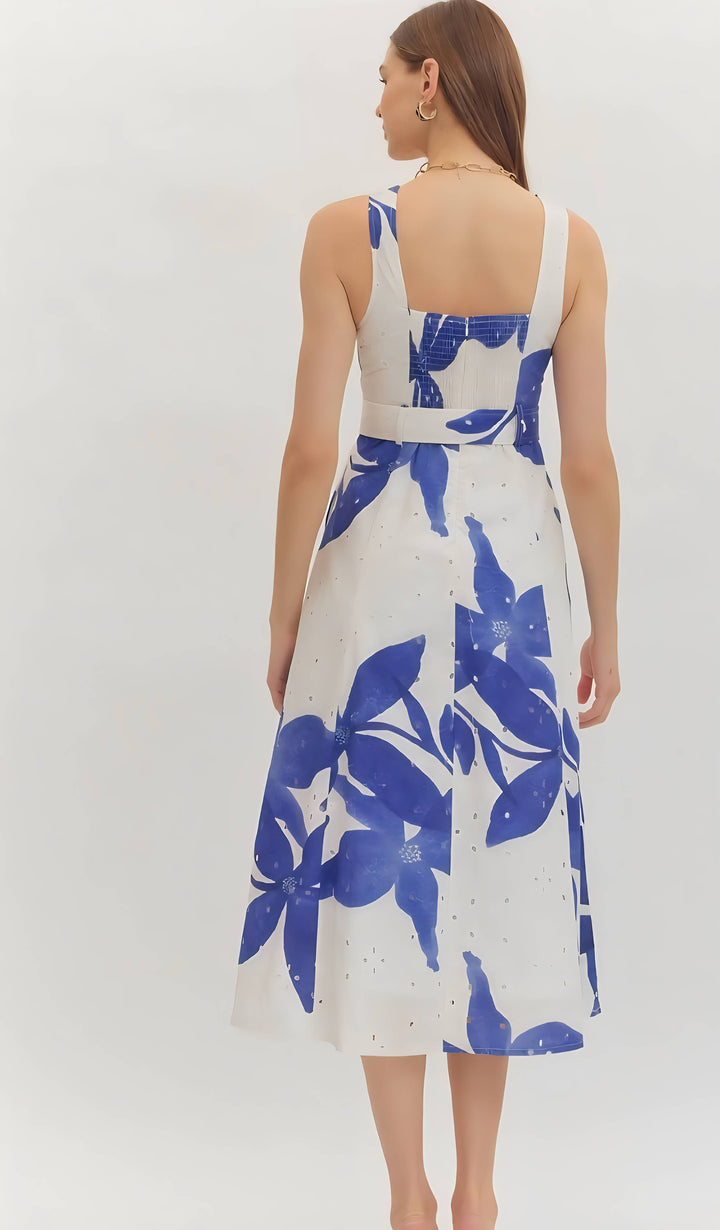 Woman wearing a blue print belted dress on a white background