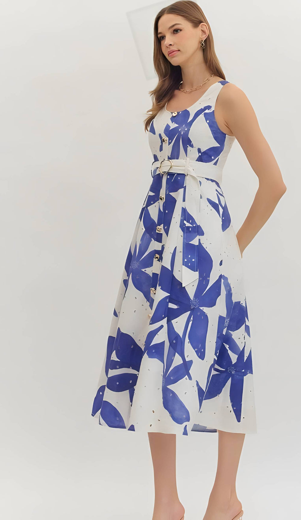 Woman wearing a blue print belted dress on a white background
