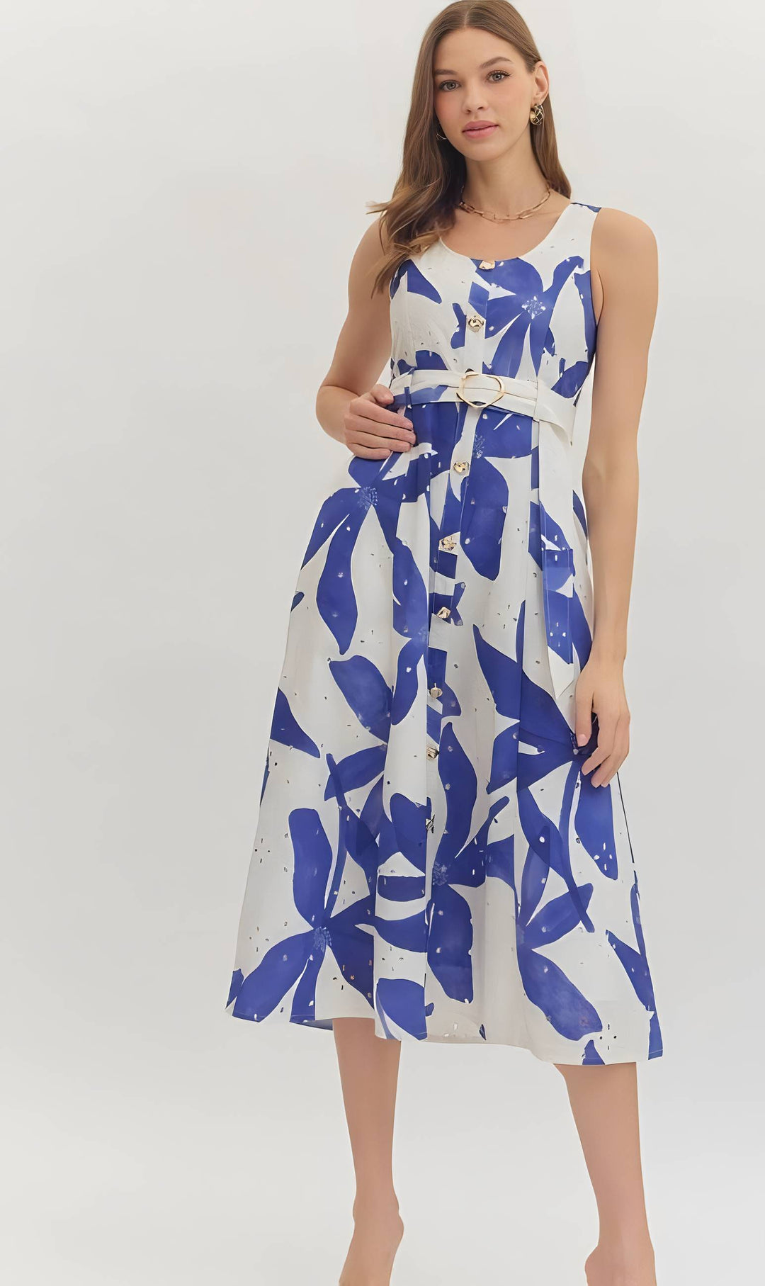 Woman wearing a blue print belted dress on a white background