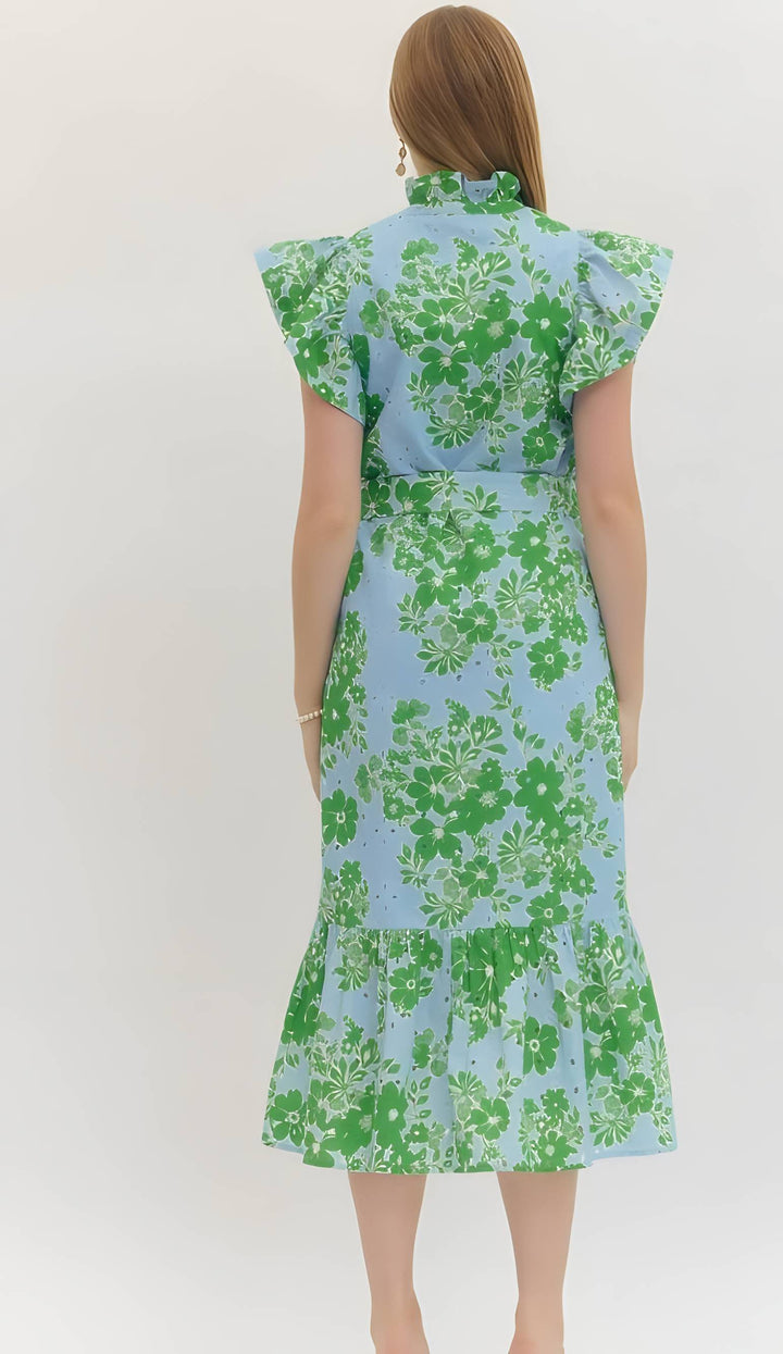 Woman wearing a green floral dress on a white background