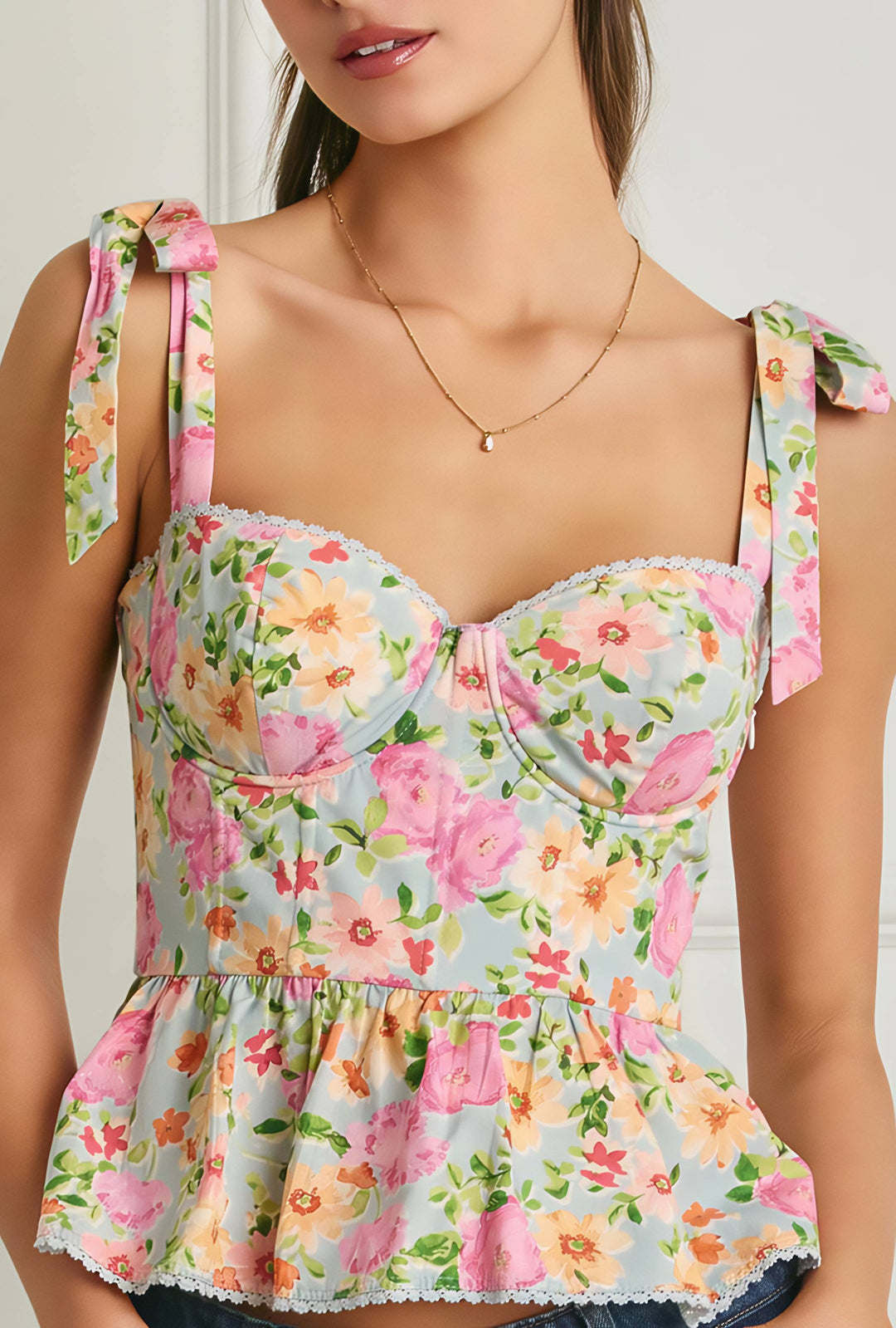 Floral print top worn by a model against a neutral background