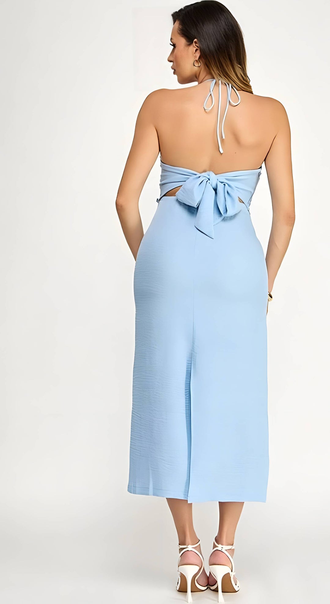 Light blue halter neck dress with bow detail on a white background