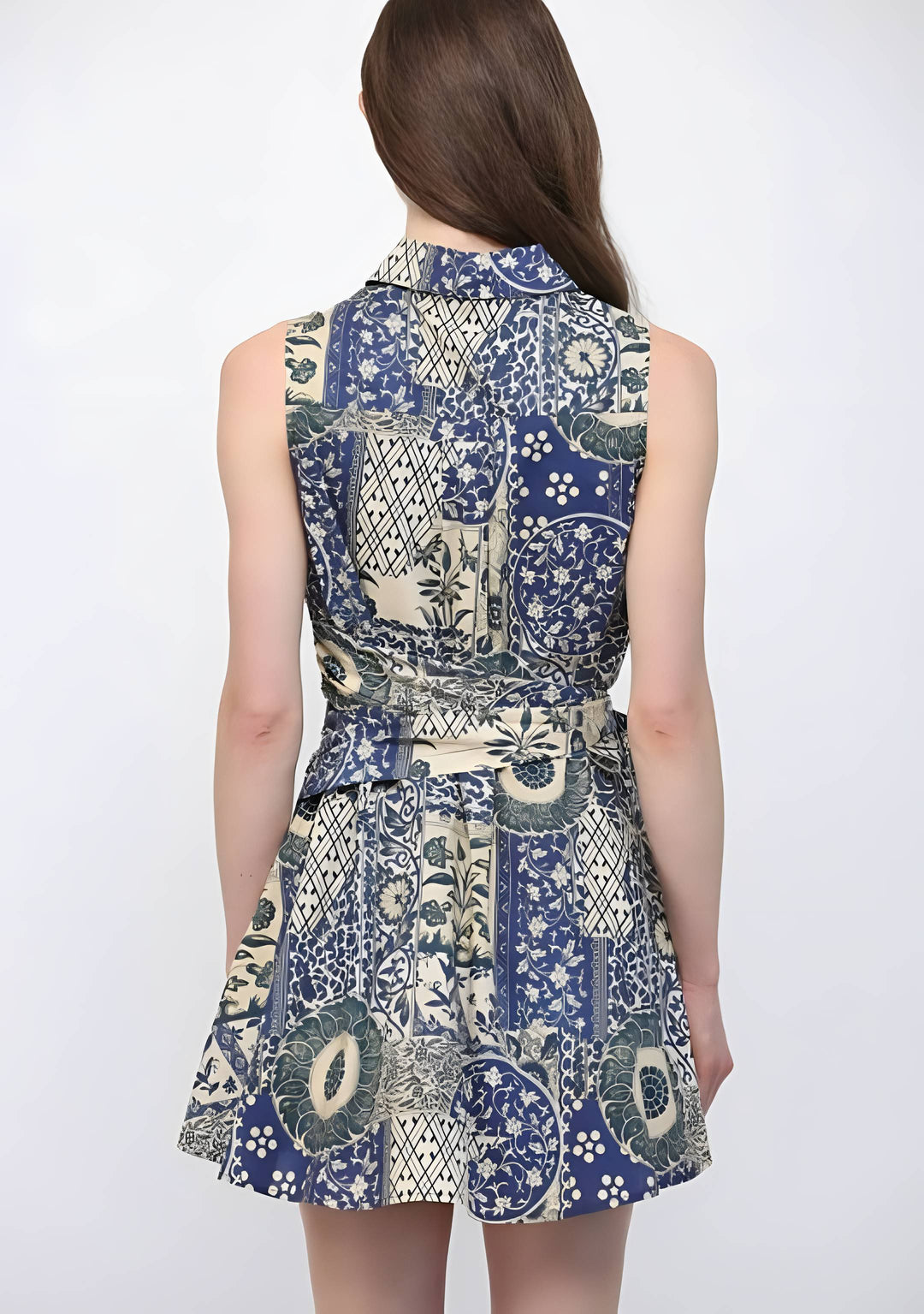 Woman wearing a sleeveless dress with a blue and white pattern on a white background