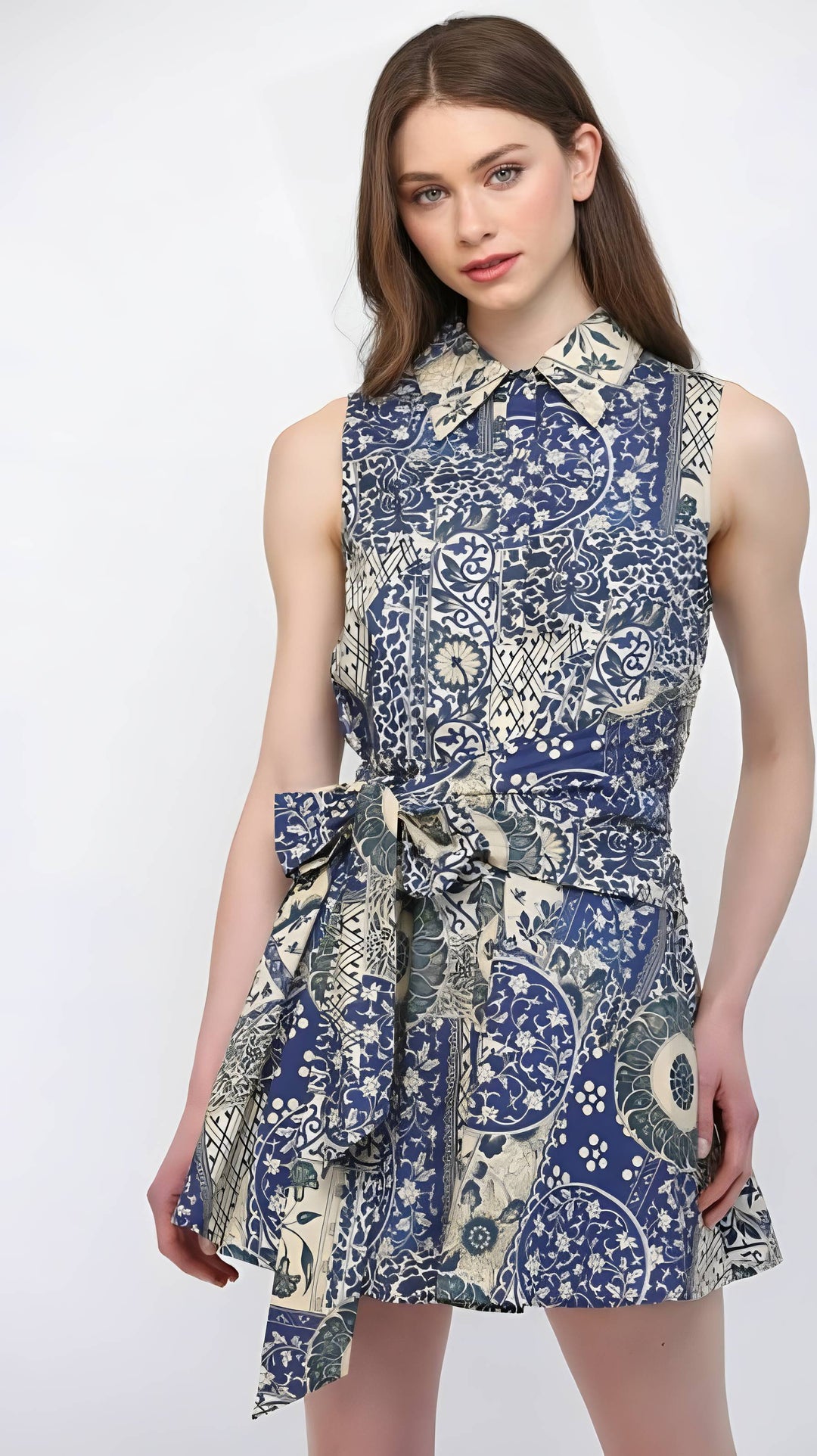 Woman wearing a blue and white patterned dress on a white background
