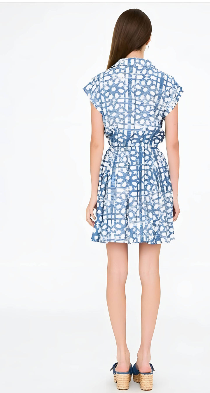 Woman wearing a blue patterned dress on a white background