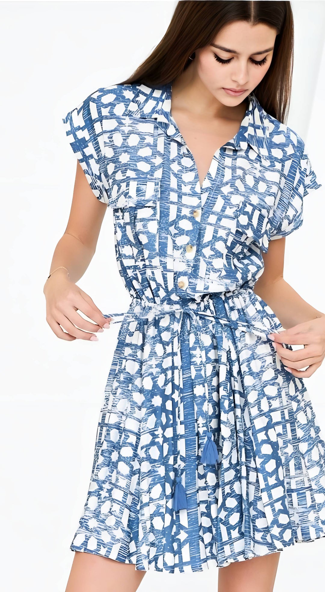 Woman wearing a blue and white patterned dress on a white background