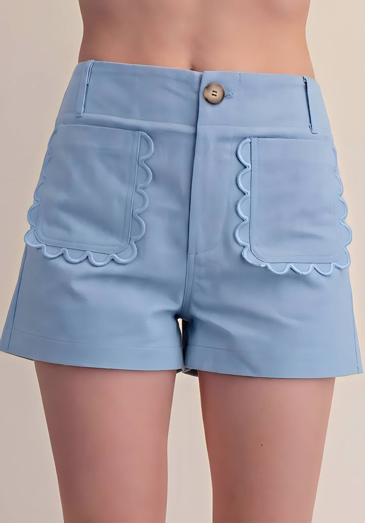 Blue shorts with scalloped detail pockets on a white backgrouund