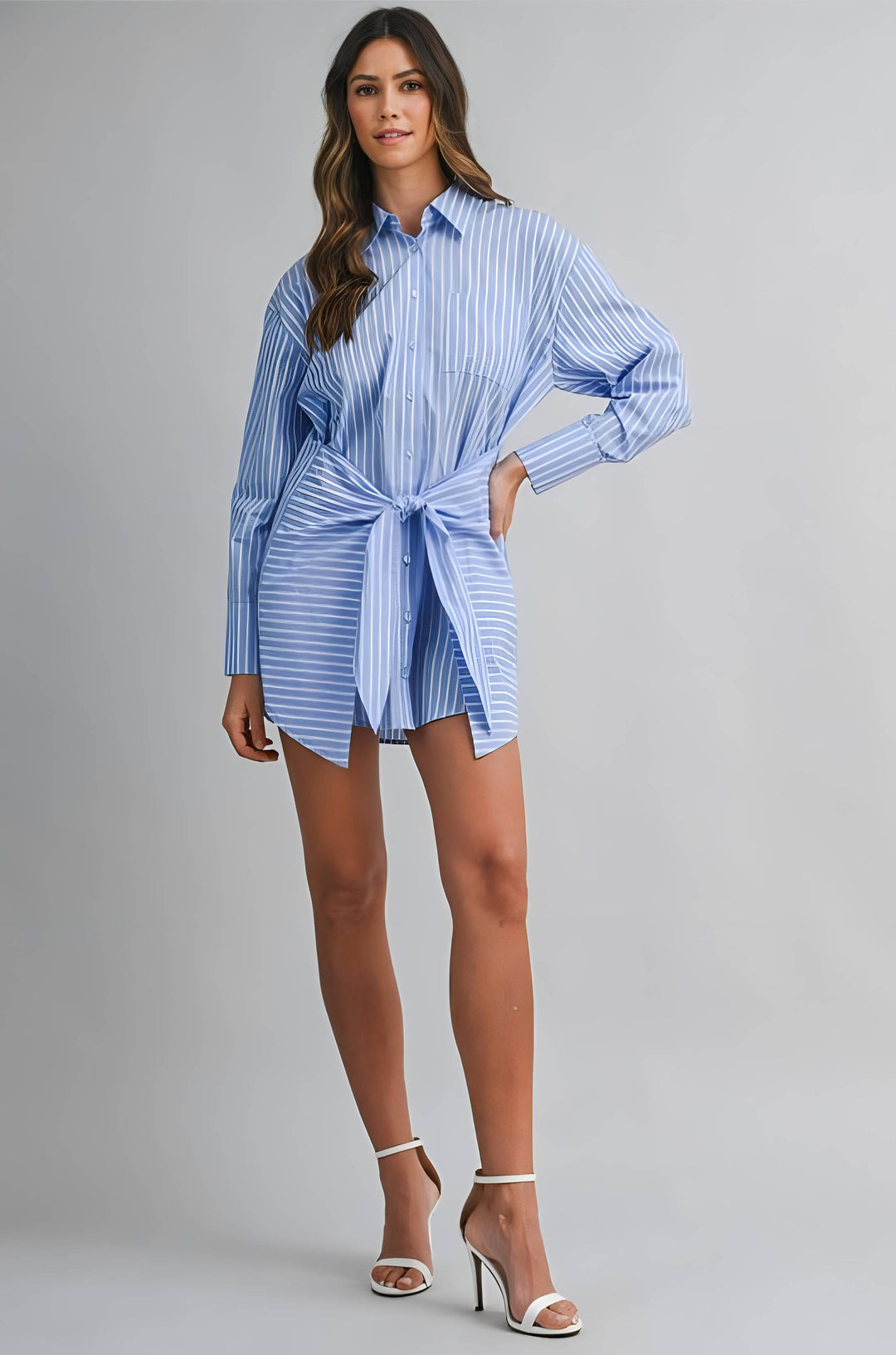 Woman wearing a blue and white striped shirt dress on a gray background