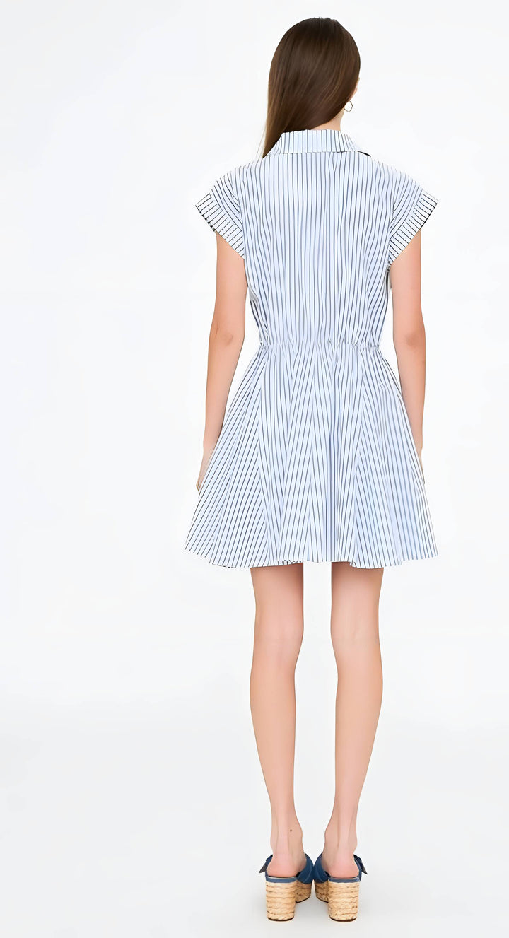 Woman wearing a blue and white striped dress on a white background