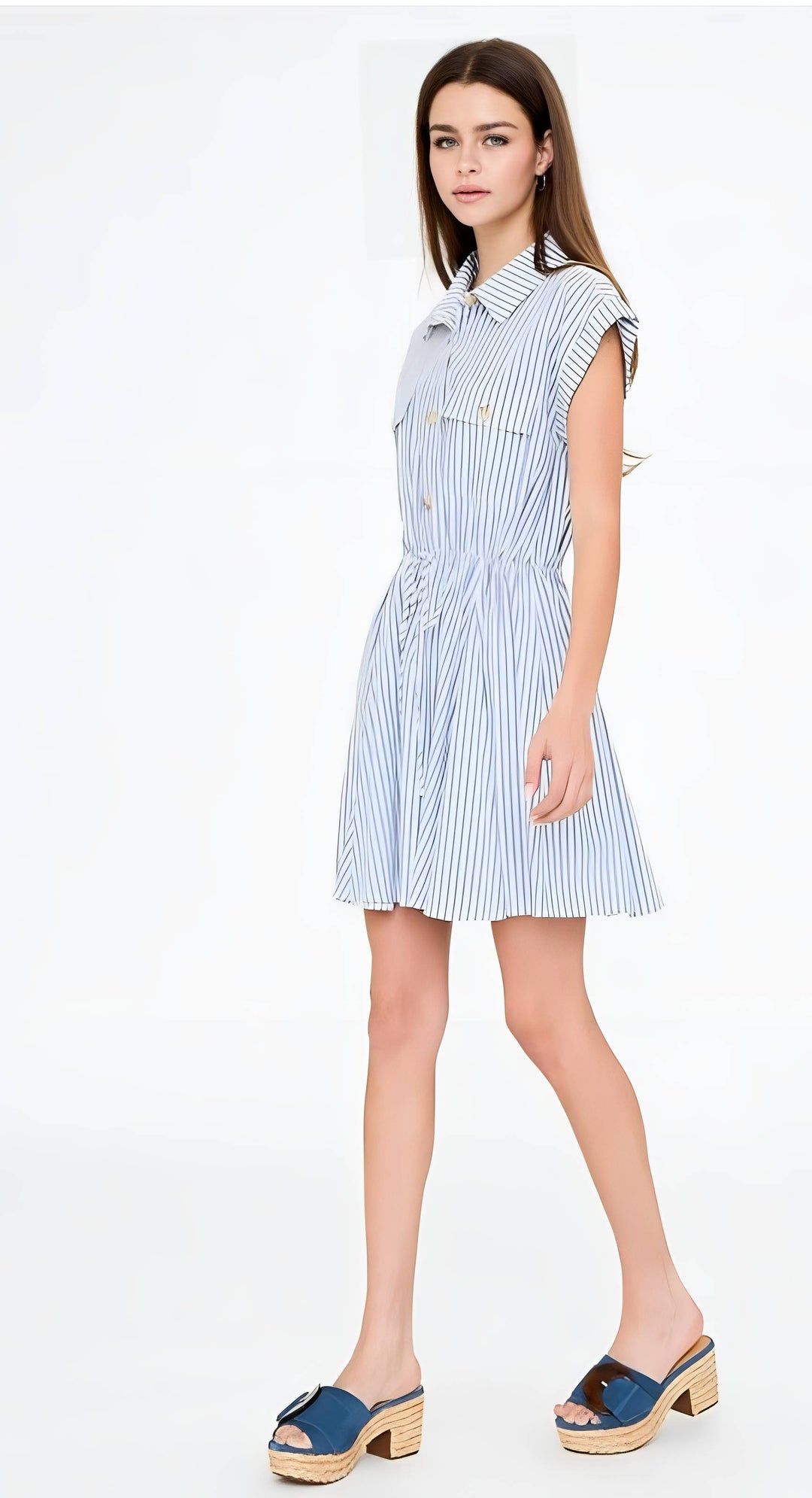 Woman wearing a blue and white striped dress on a white background