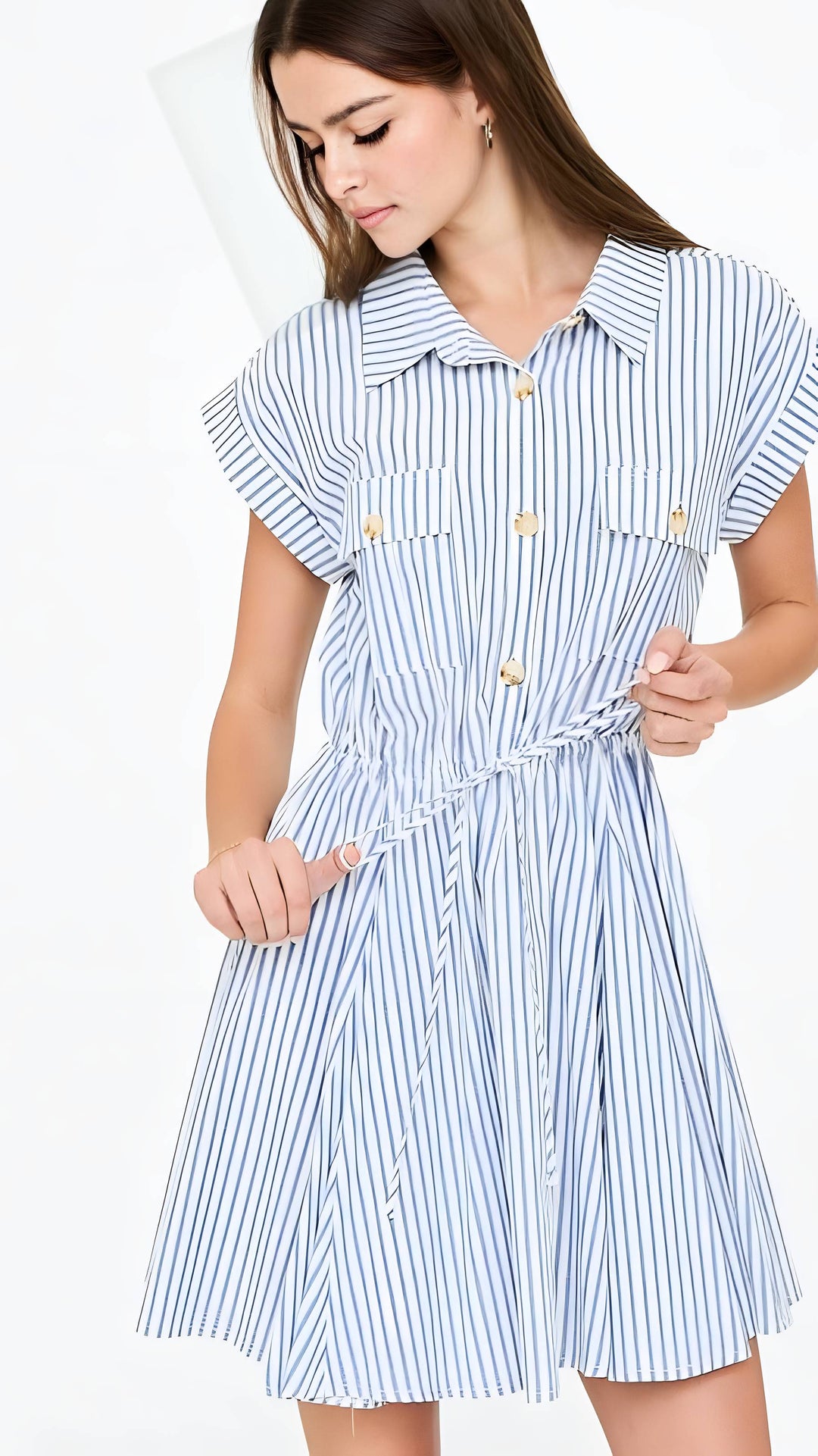 Woman wearing a blue and white striped dress on a white background