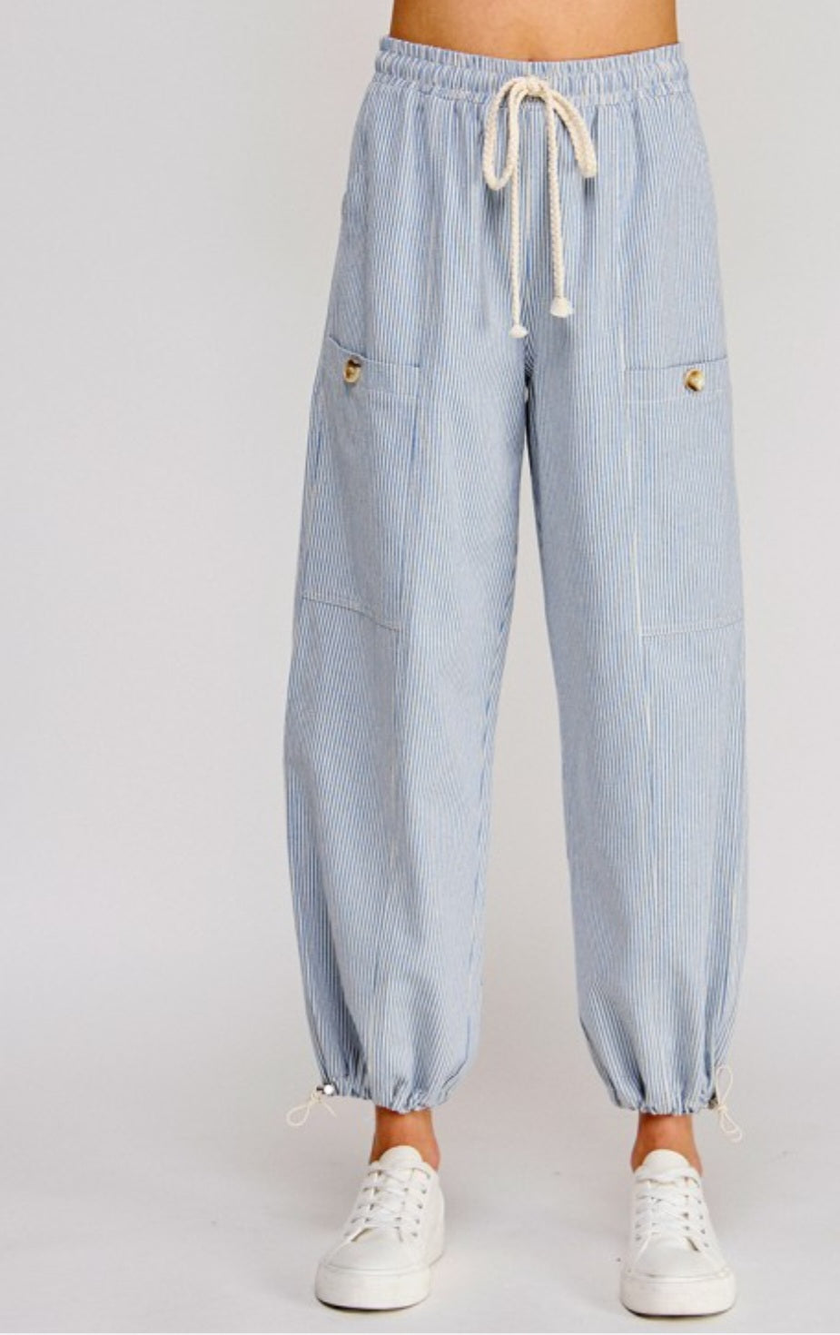 Light blue striped pants with drawstring on a white background