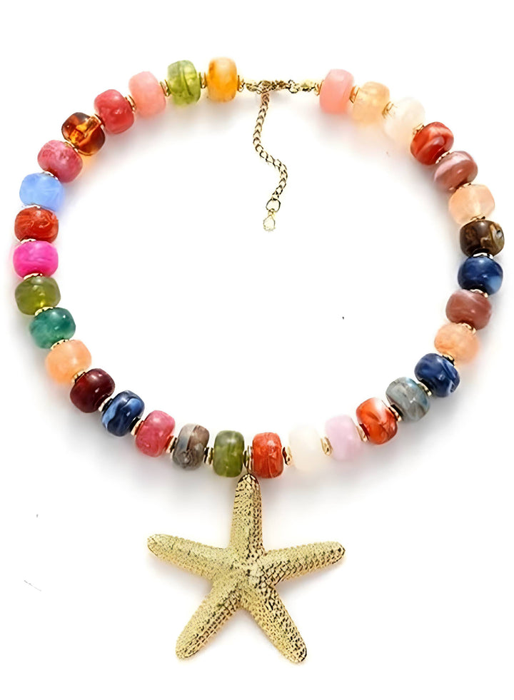 A multicolor beaded necklace with a textured gold starfish pendant, displayed on a clean white background.