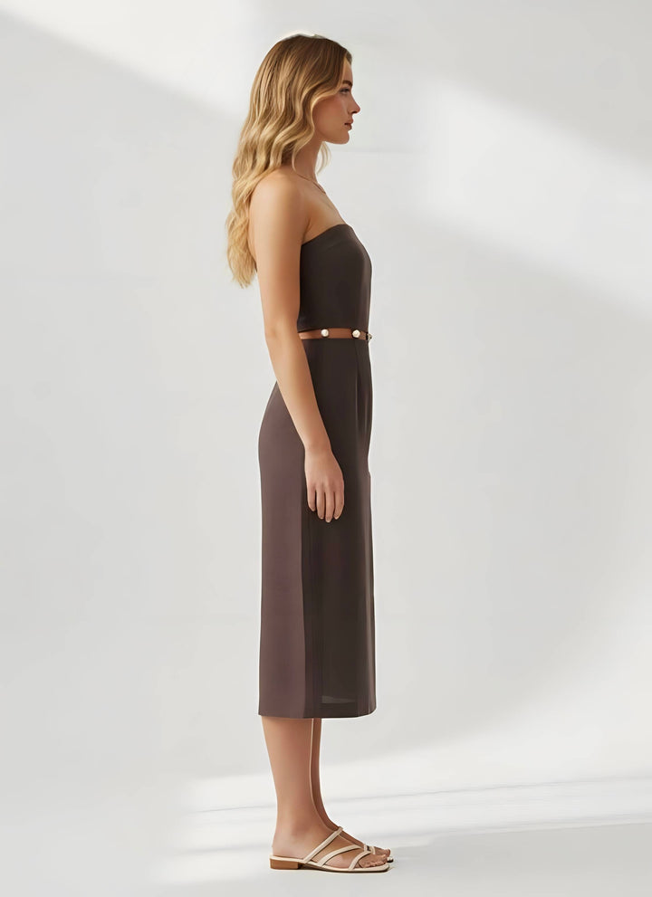 Woman wearing a strapless brown dress on a white background