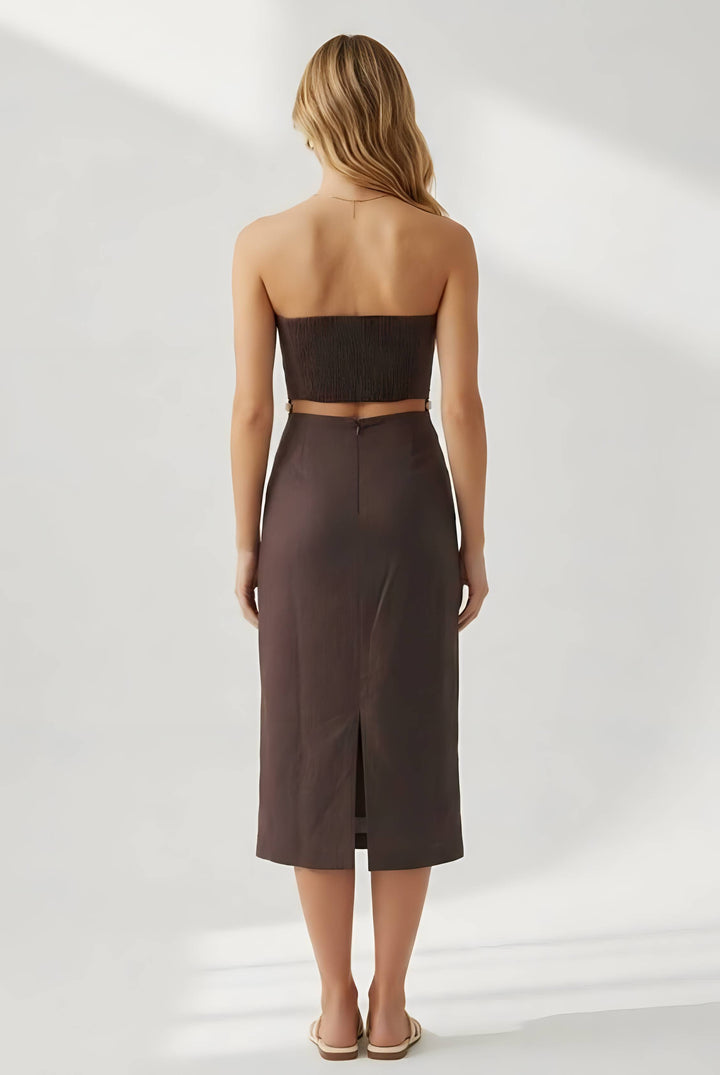 Woman wearing a strapless brown dress on a white background