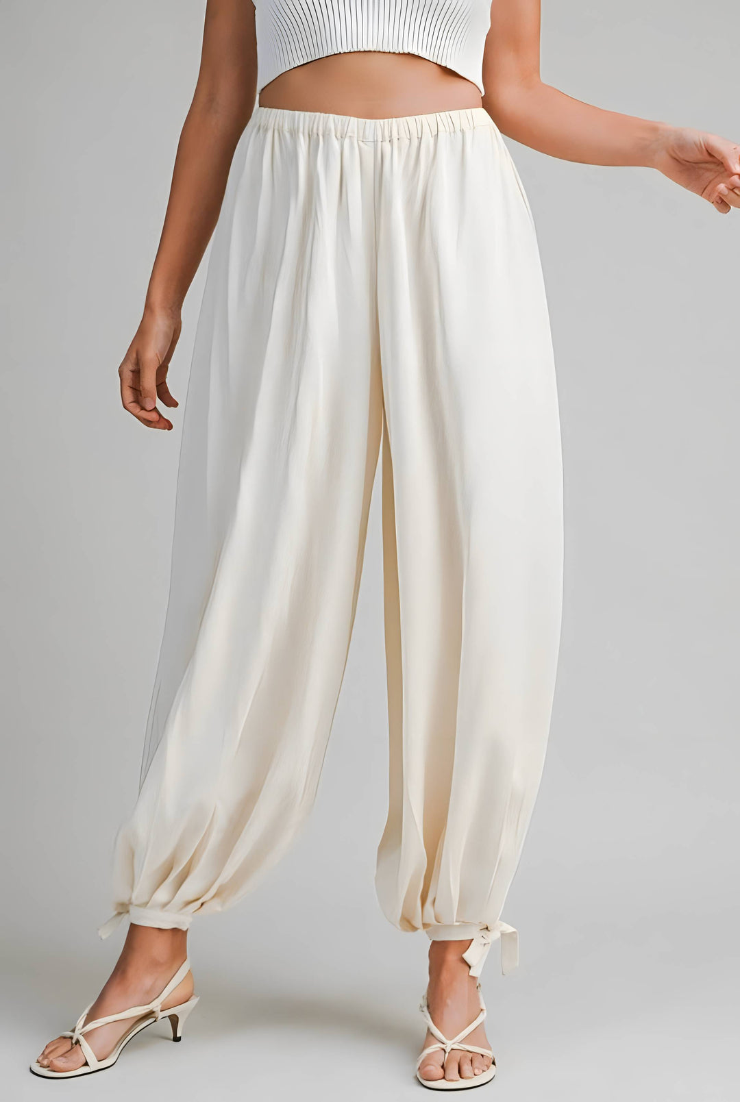 White wide-leg pants worn by a person on a gray background