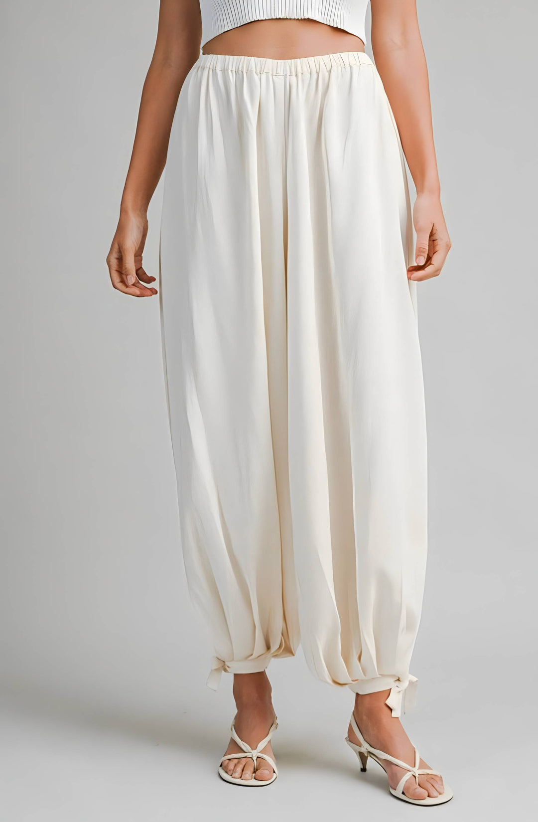 Cream wide-leg pants worn by a person on a plain background