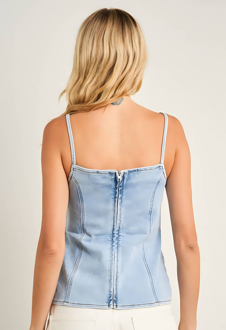 Light blue denim tank top worn by a person on a plain background