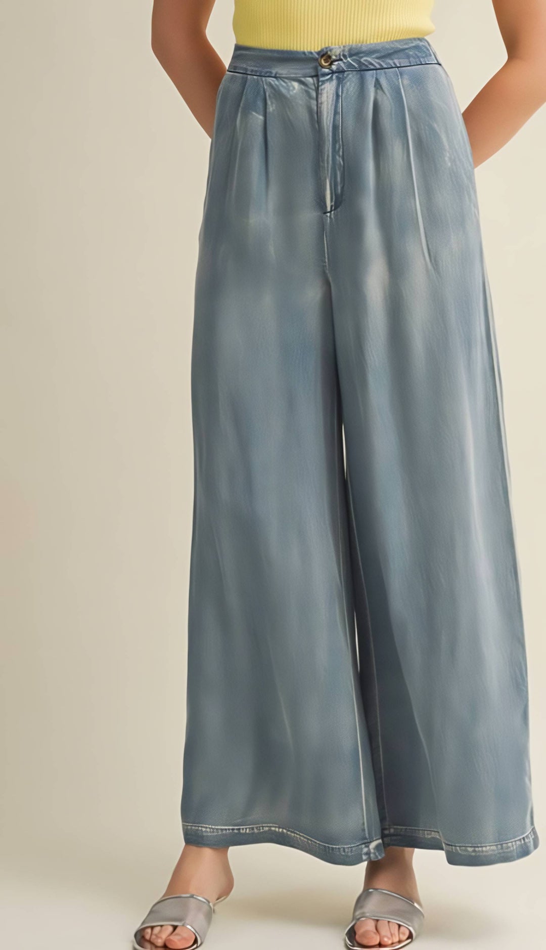 Light blue wide-leg pants worn by a person on a beige background