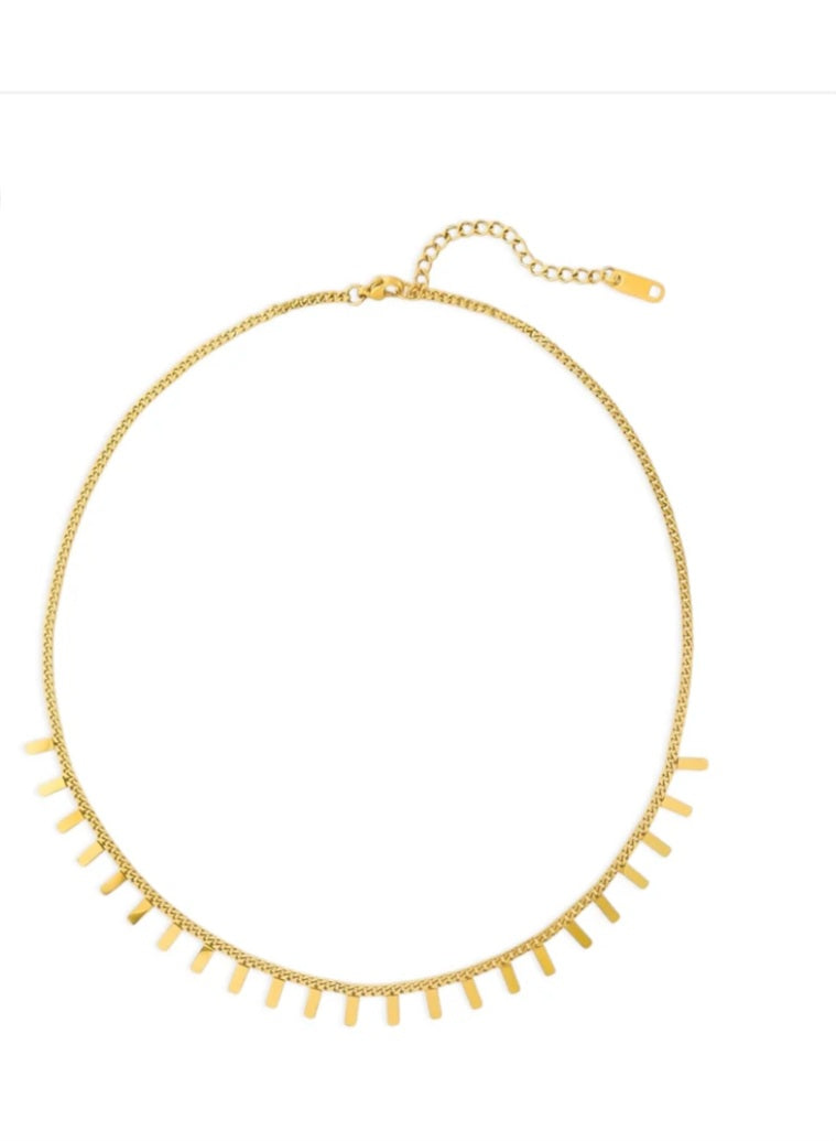 Gold necklace with fringe design on a white background