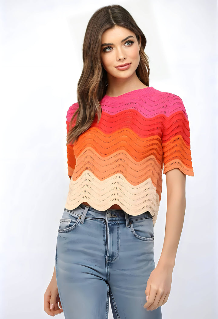 Woman wearing a colorful striped sweater and jeans on a white background
