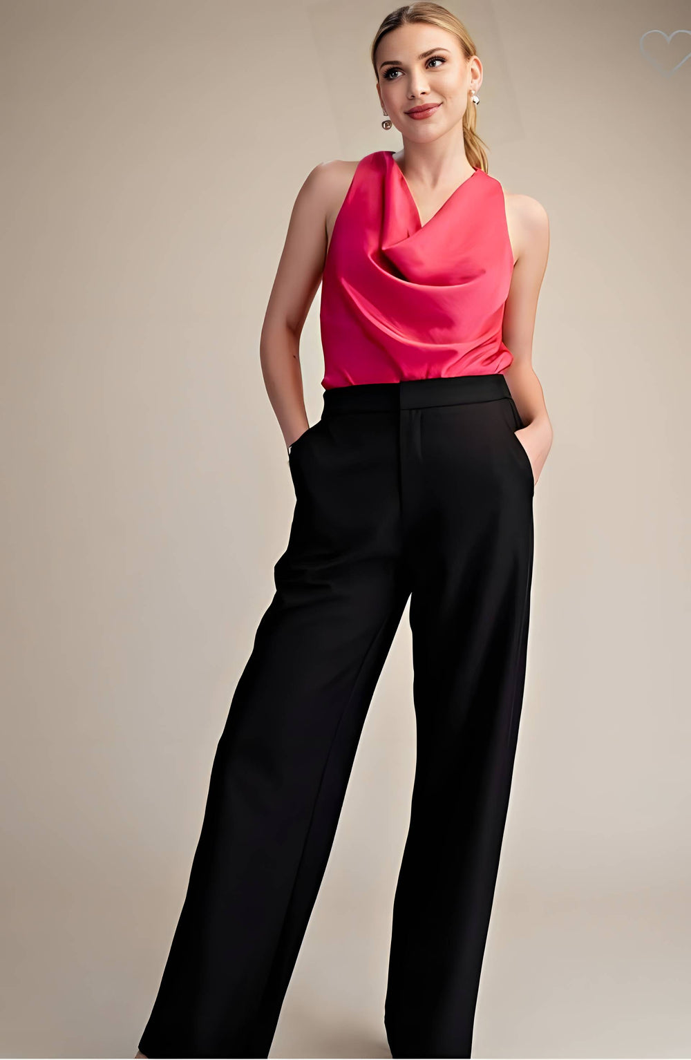 Woman wearing a bright pink sleeveless top and black pants against a beige background