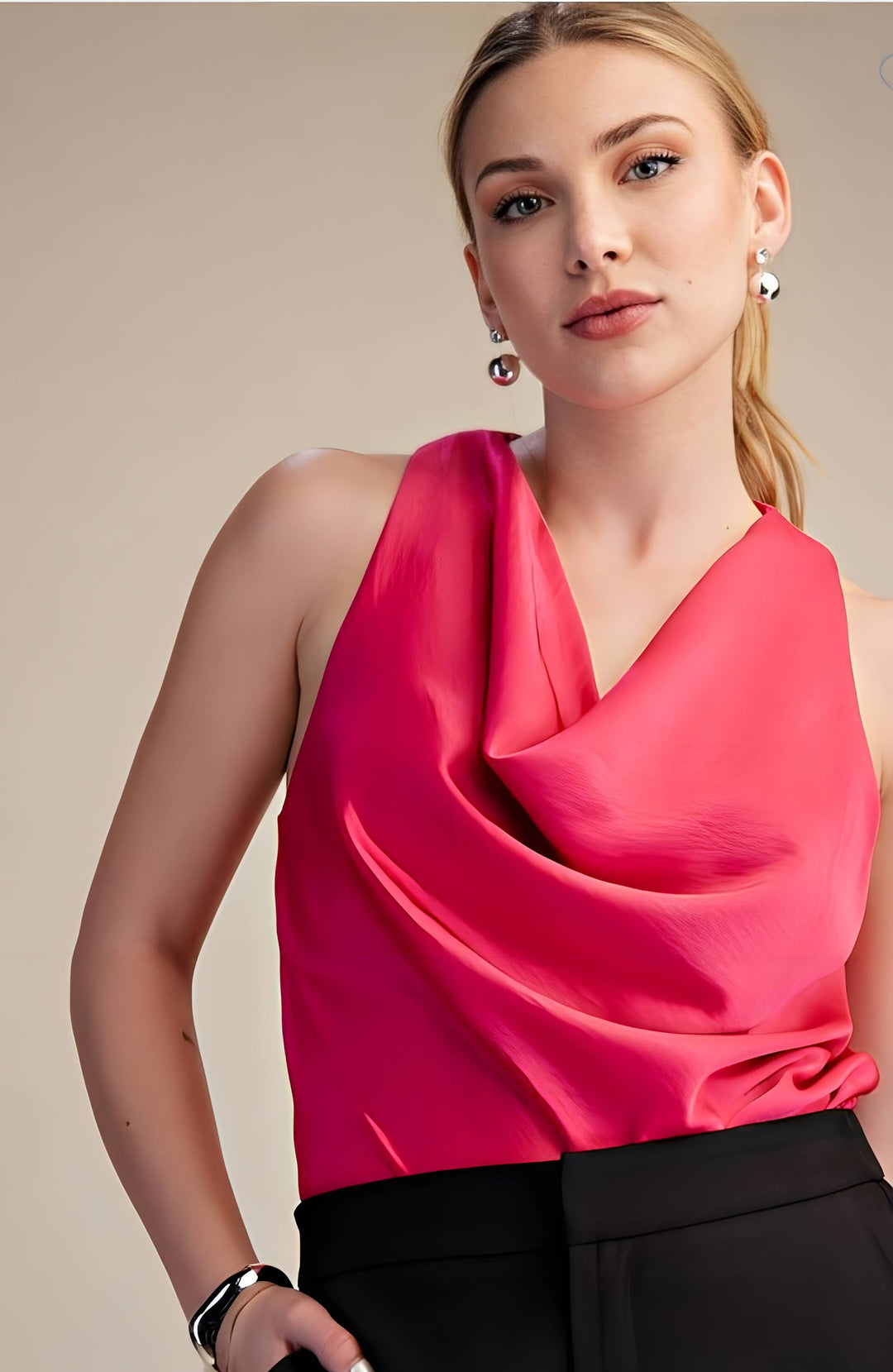 Woman wearing a bright pink sleeveless top against a beige background