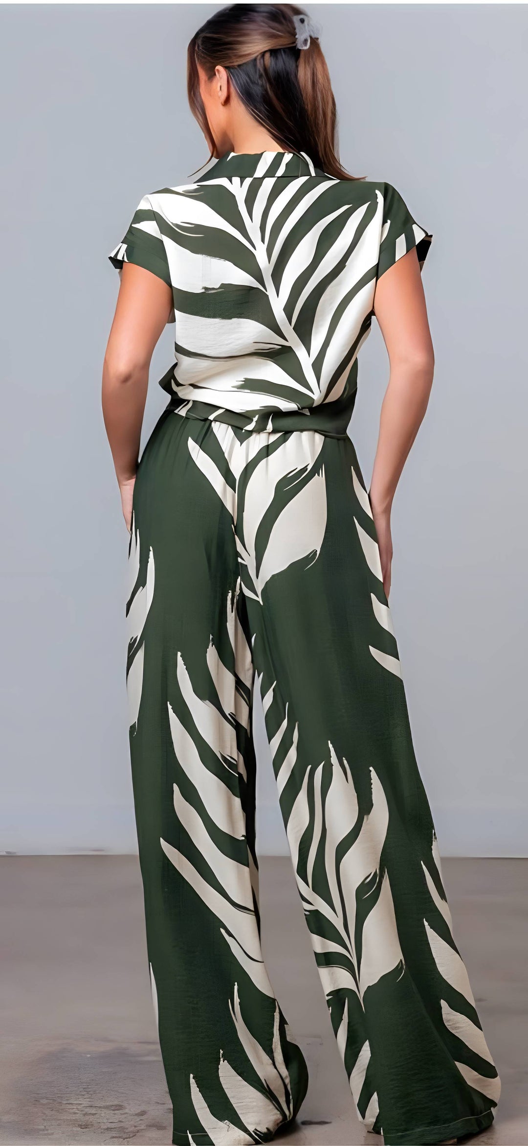 Person wearing a green and white patterned outfit against a gray background