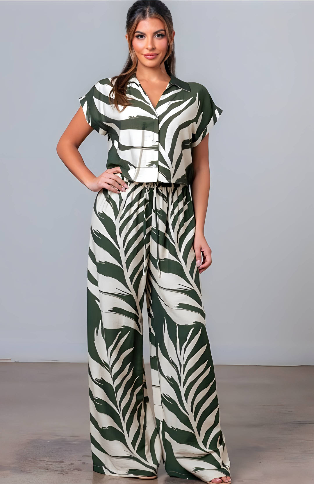 Woman wearing a green and white patterned outfit against a plain background