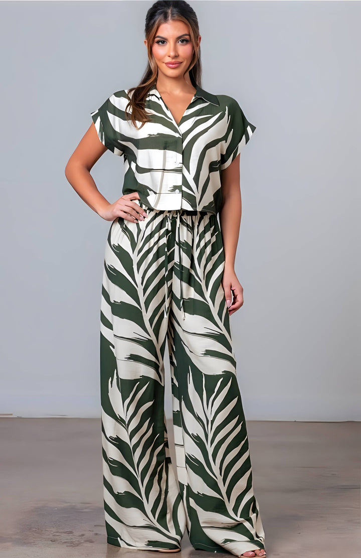 Woman wearing a green and white patterned outfit against a plain background