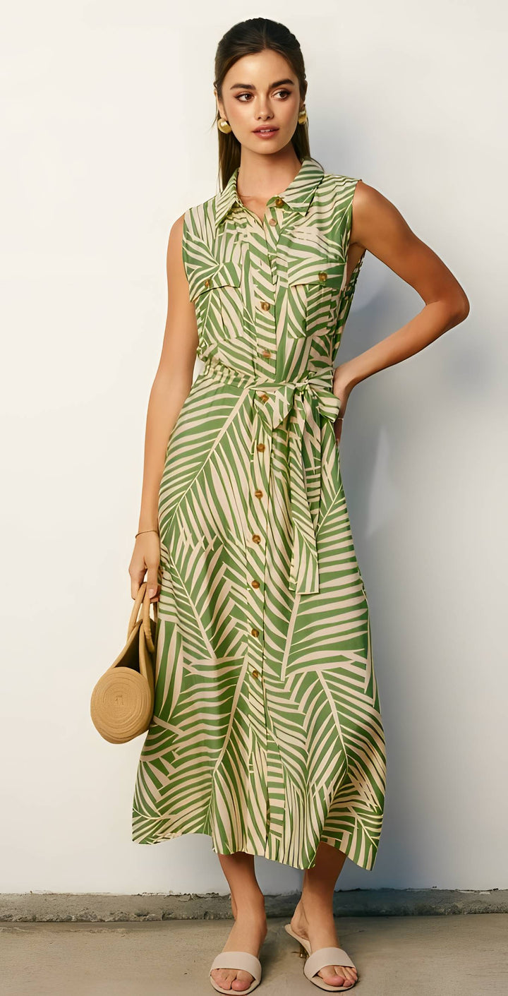 Woman wearing a green and white patterned dress against a plain background