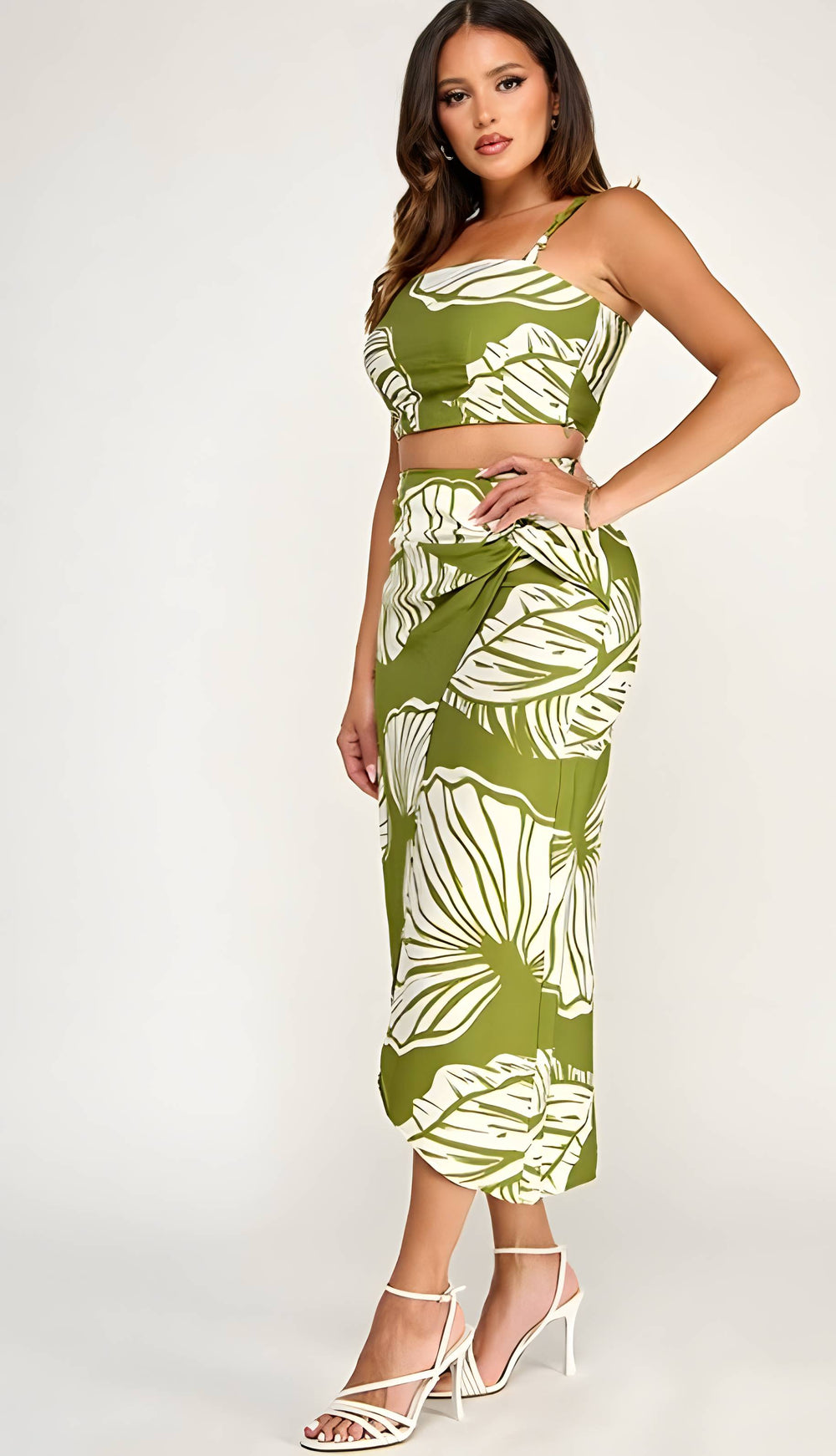 Woman wearing a green and white leaf-patterned two-piece outfit on a white background