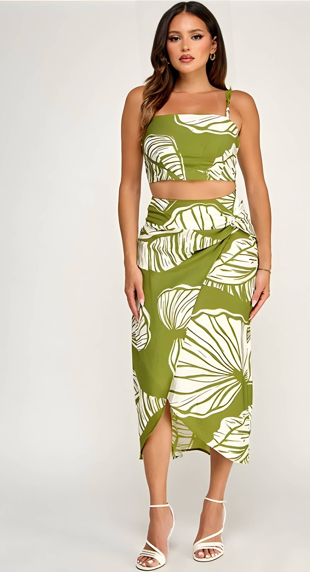 Woman wearing a green and white leaf-patterned dress on a white background