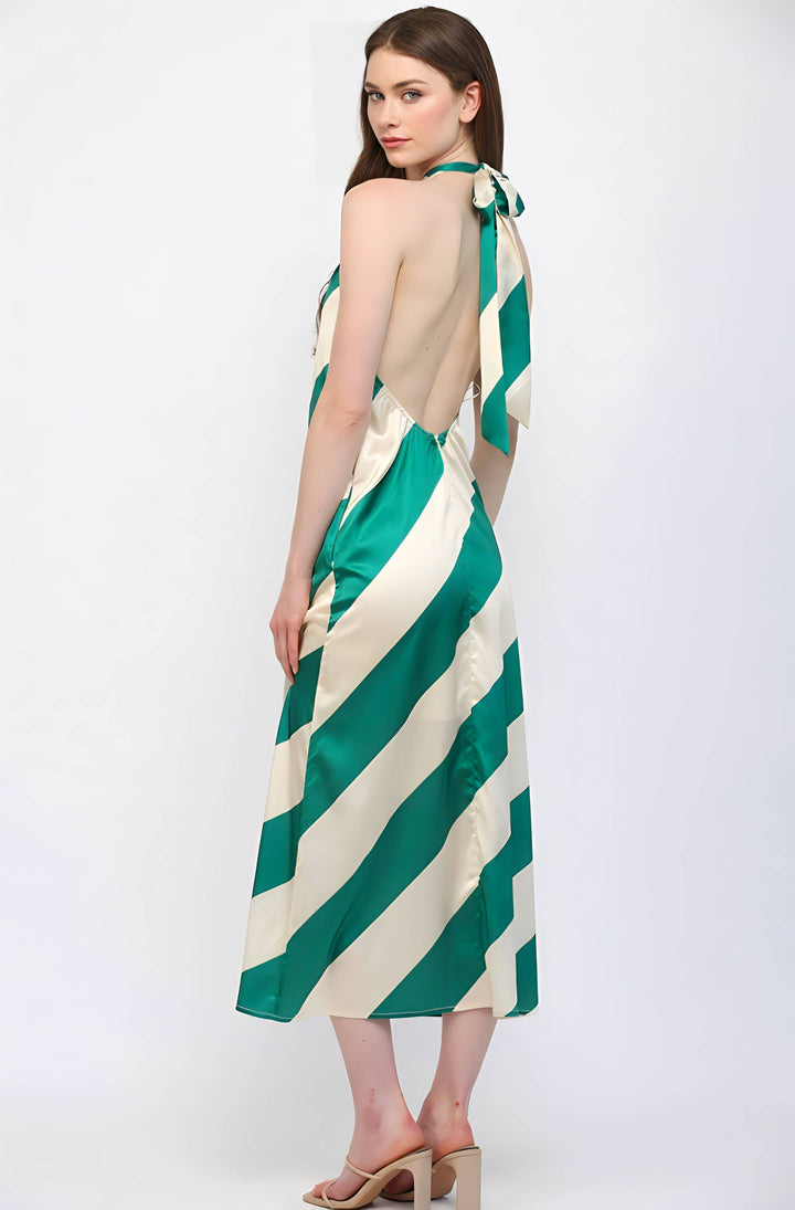 Woman wearing a green and white striped dress on a white background
