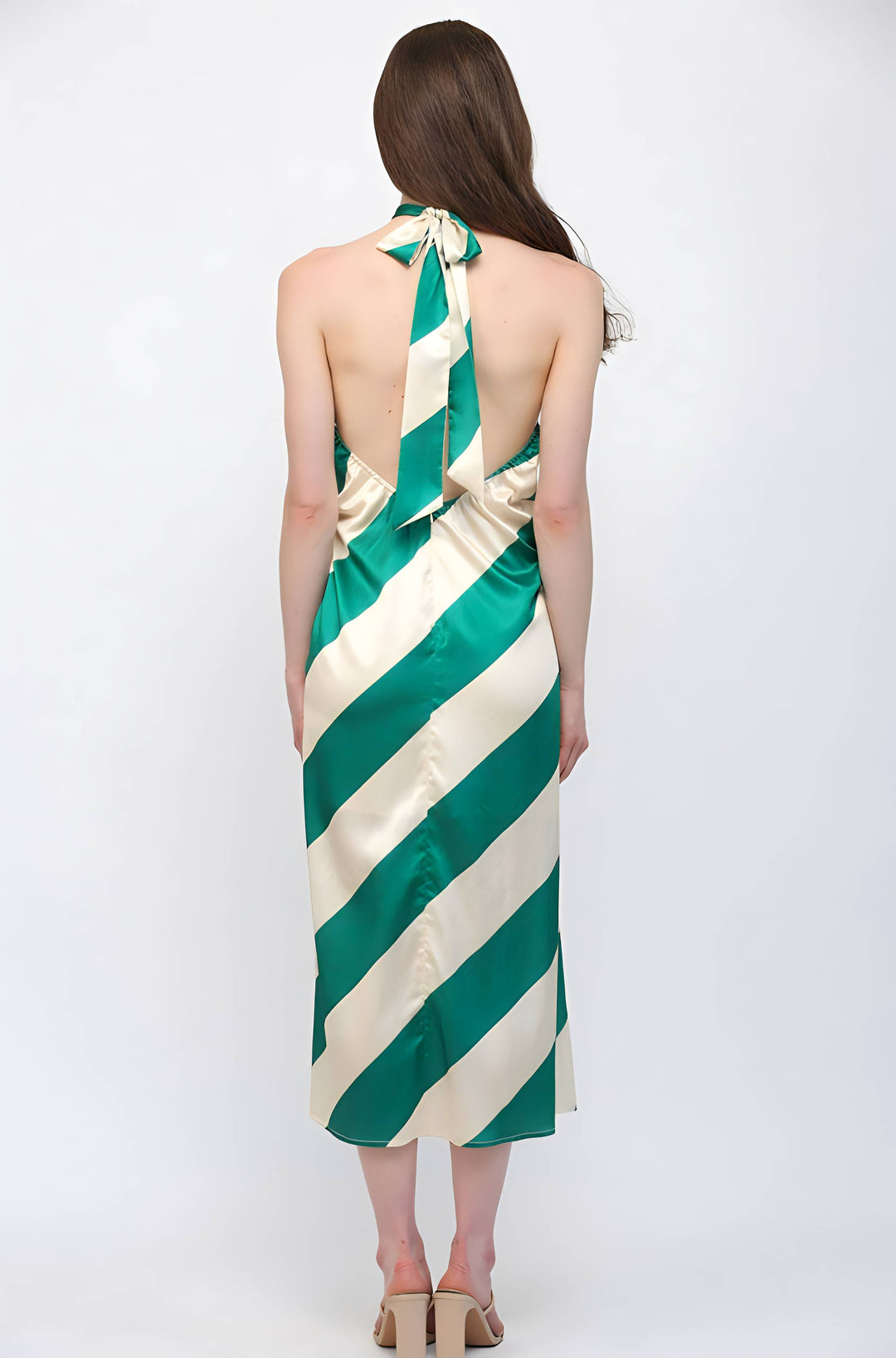 Woman wearing a green and white striped dress on a white background