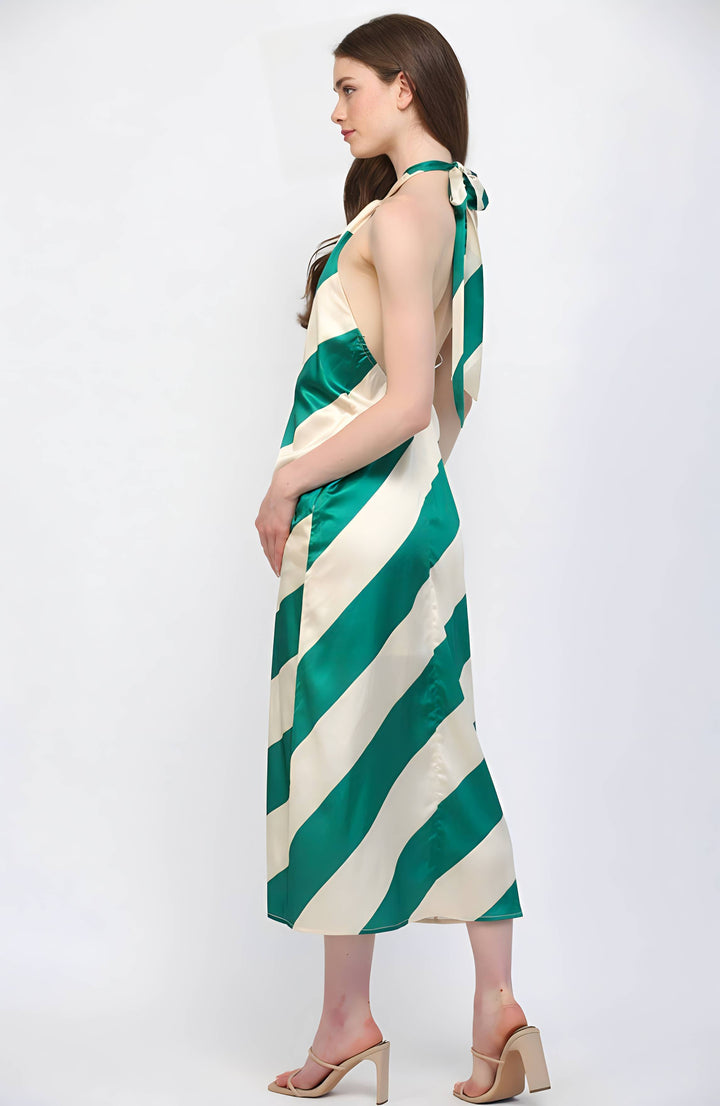 Woman wearing a green and white striped dress on a white background