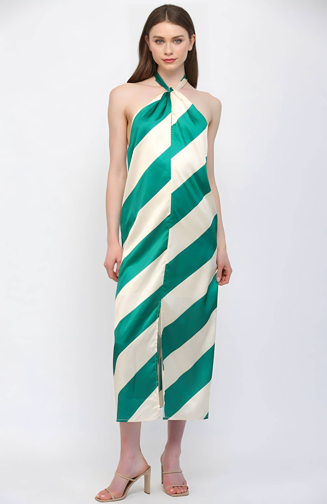 Woman wearing a green and white striped halter neck dress on a white background