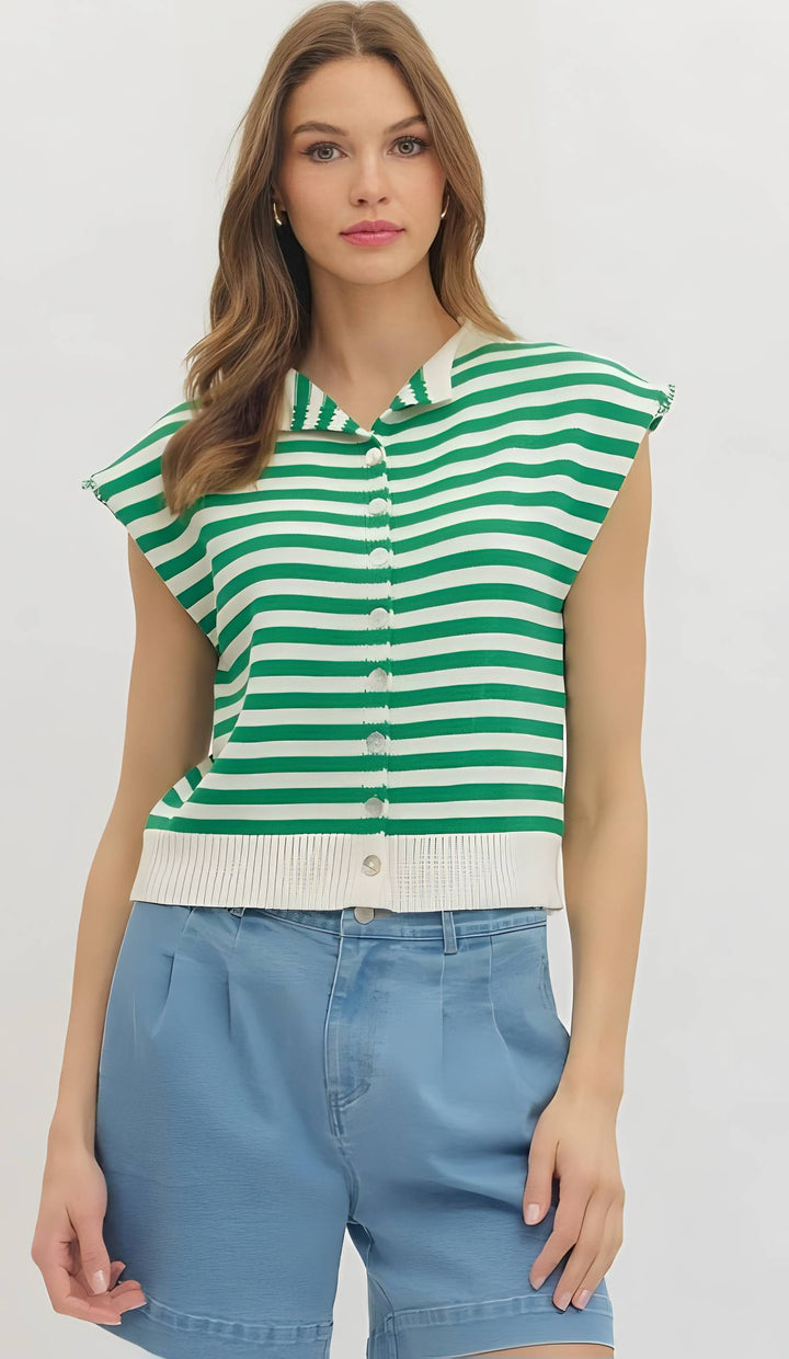 Woman wearing a green and white striped shirt with blue shorts on a white background
