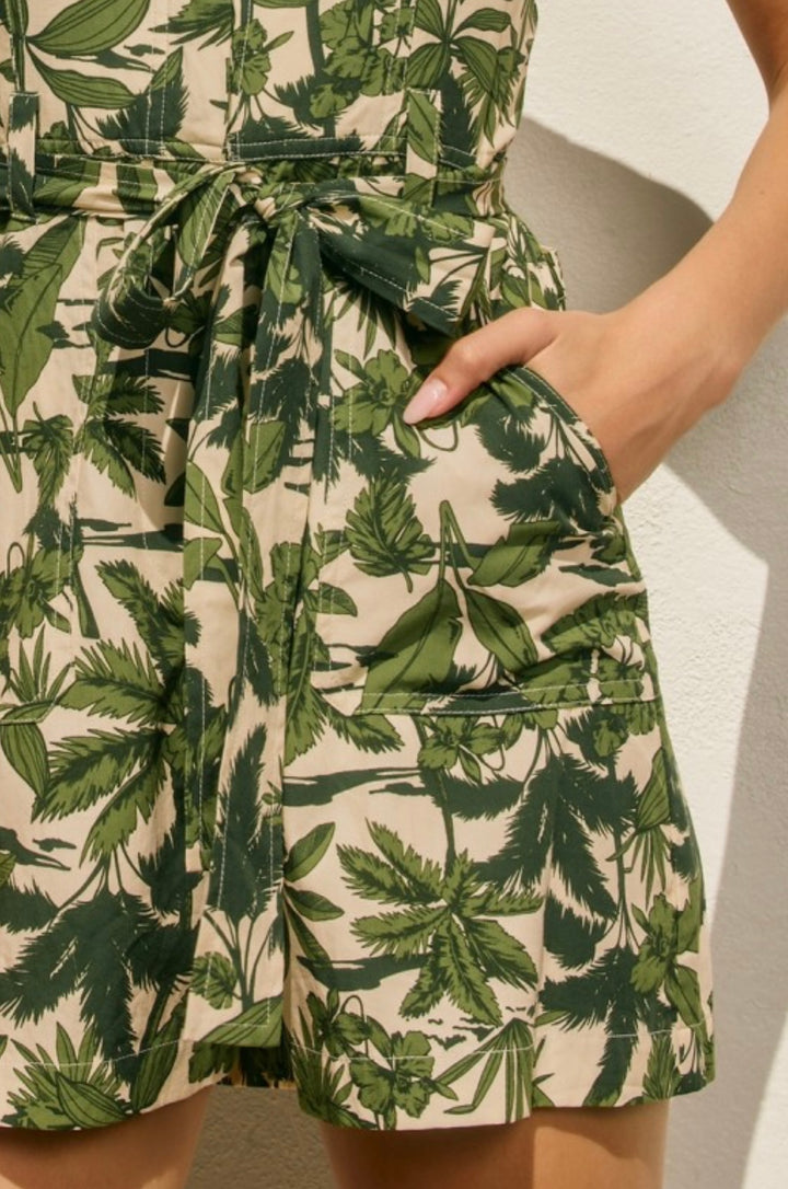 Green leaf-patterned shorts on a neutral background