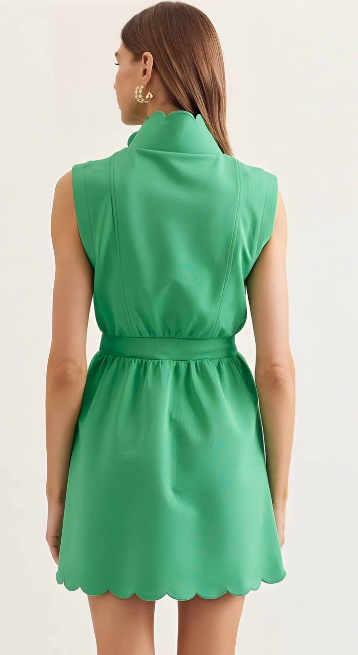Green dress worn by a model on a plain background