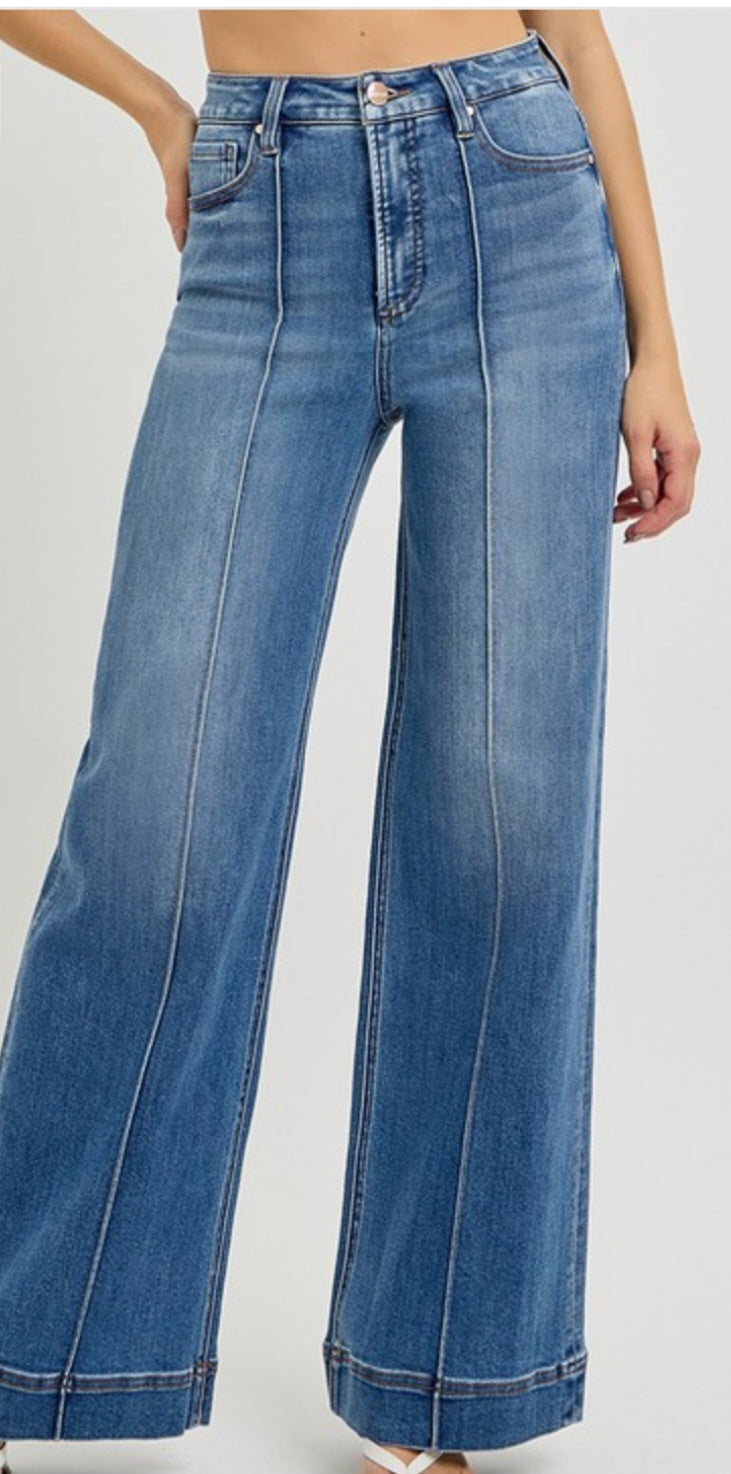 Wide-leg jeans with front pintuck worn by a person on a white background