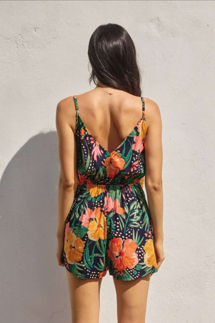 Chic navy blue romper featuring floral print and wrap front design