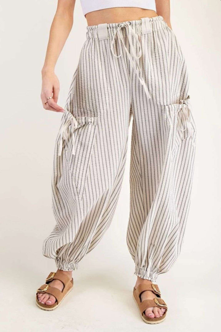Women's ivory stripe joggers with elastic waistband and side pockets – casual, comfortable athleisure pants for everyday wear.
