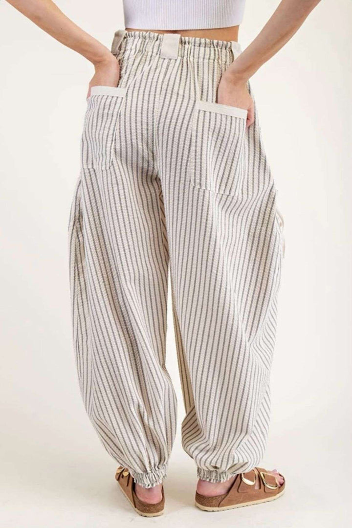 Women's ivory stripe joggers with elastic waistband and side pockets – casual, comfortable athleisure pants for everyday wear.