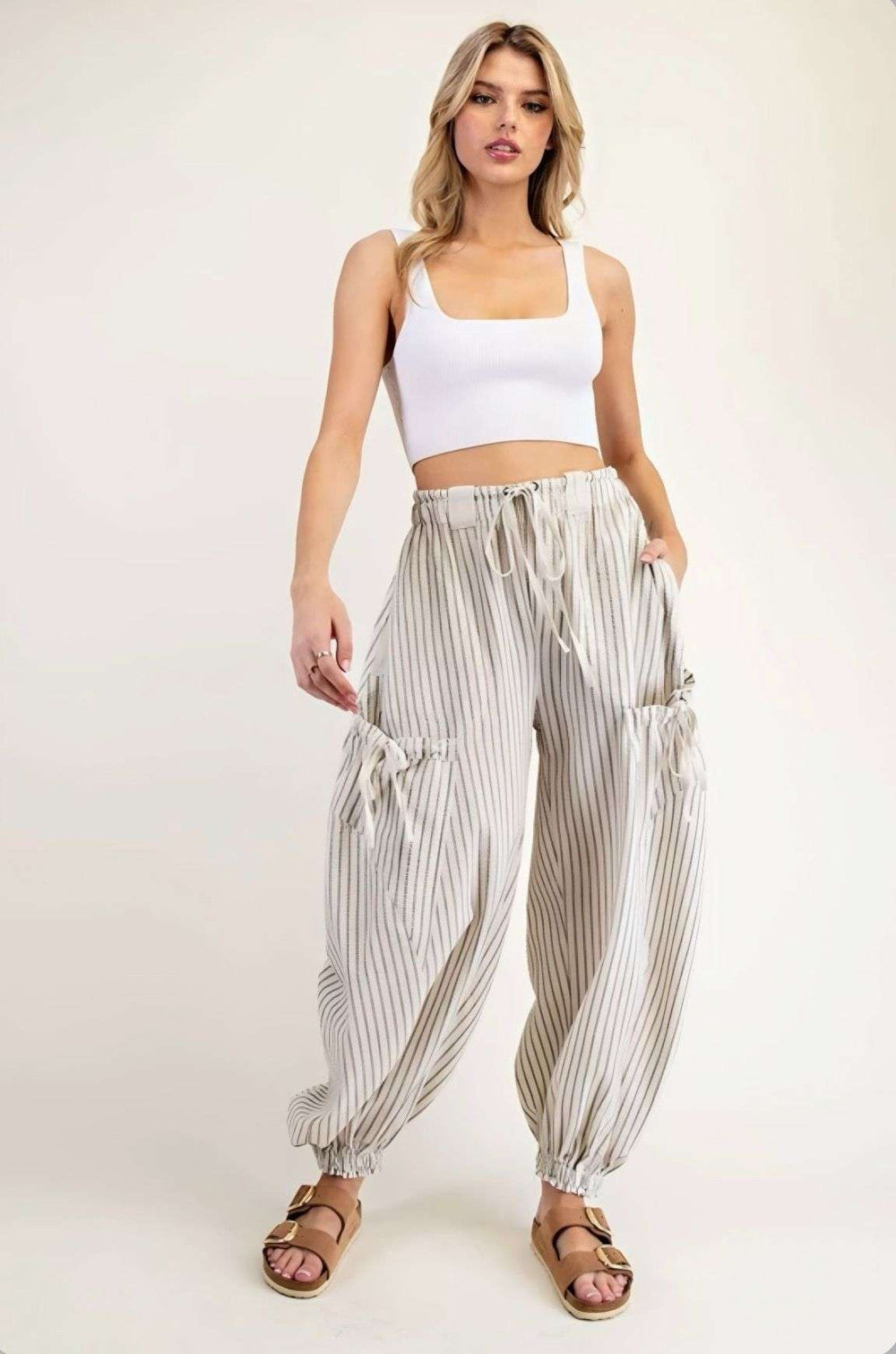 Women's ivory stripe joggers with elastic waistband and side pockets – casual, comfortable athleisure pants for everyday wear.