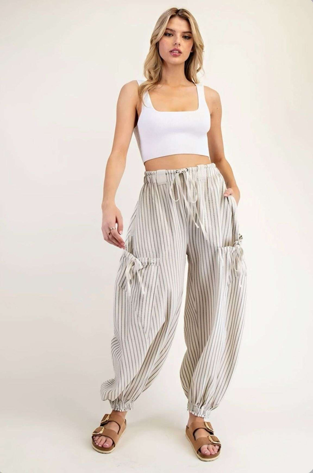 Women's ivory stripe joggers with elastic waistband and side pockets – casual, comfortable athleisure pants for everyday wear.