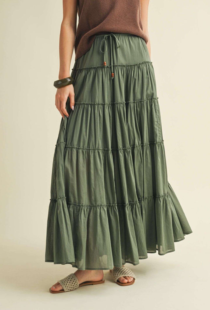 Flowy olive tiered maxi skirt for women – boho-inspired long skirt with layered design, perfect for casual wear and vacation style.